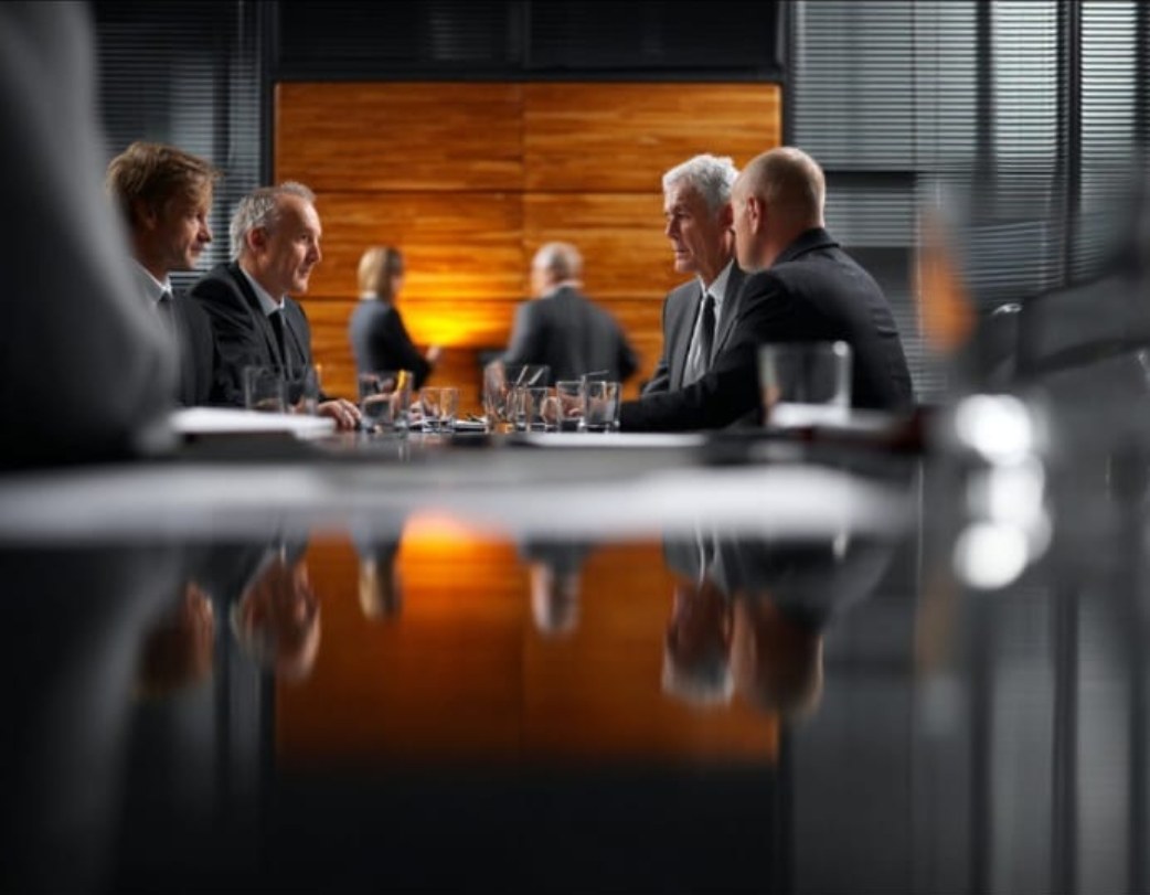 Executive boardroom discussion at dusk